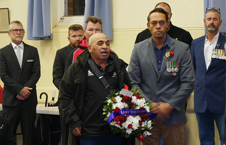 Community members participating in the wreath laying ceremony at Harvey Town Hall.