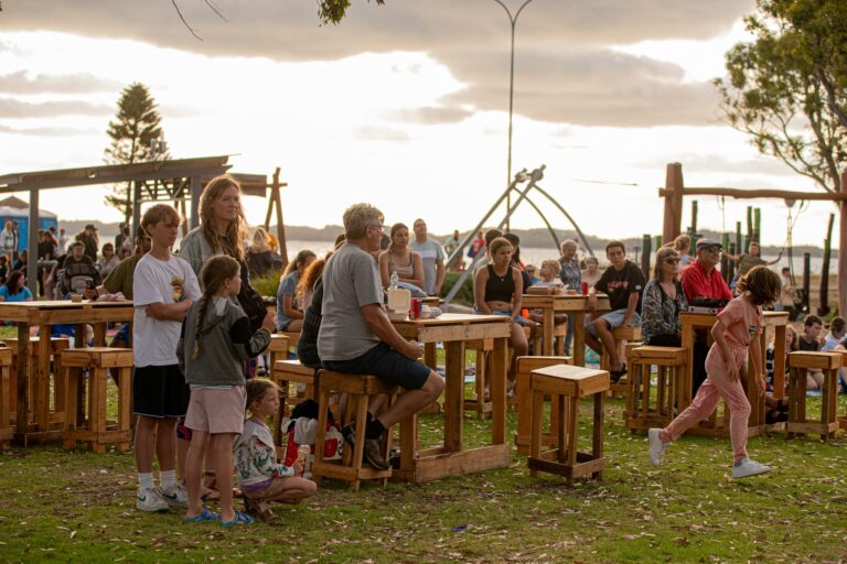 A family chills out at a picnic bench